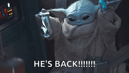 a baby yoda is holding a bag of chips and says he 's back !
