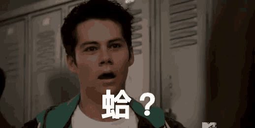 a man is standing in front of lockers with his mouth open and a question mark on his chest .