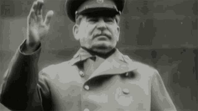 a man in a military uniform is waving his hand in a black and white photo