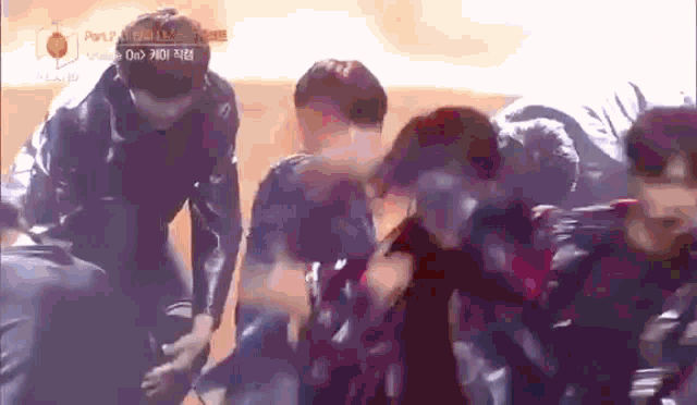 a group of people are standing in a circle and one of them is holding another person 's arm