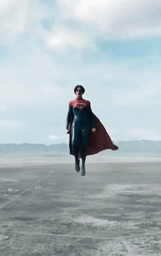 a person in a superman costume is flying through the air