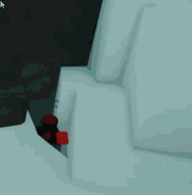 a person in a red hat is standing next to a white wall .
