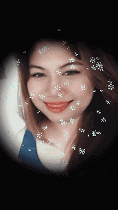 a close up of a woman 's face with snowflakes coming out of it