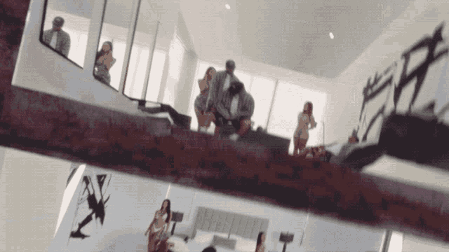 a group of people are standing in a room with a sign that says ff on it