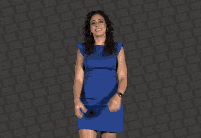 a woman in a blue dress is making a heart shape with her hands in front of a fox logo