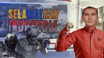 a man stands in front of a sign that says selamatkan indonesia