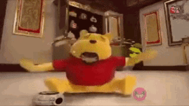 a stuffed winnie the pooh is sitting on the floor in a room with his mouth open .