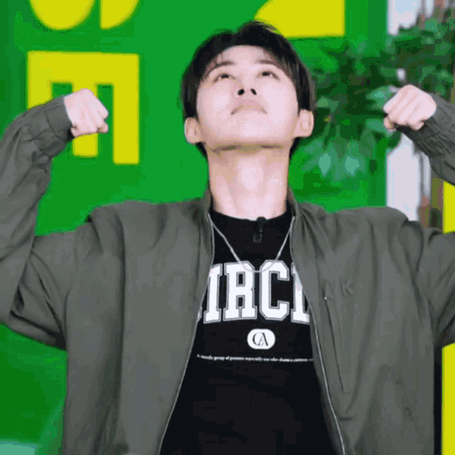 a man wearing a jacket and a shirt that says iacl on it