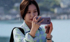 a woman is taking a picture of herself with her cell phone