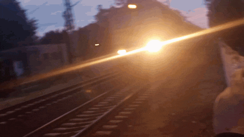 a blurred image of a train going down the tracks