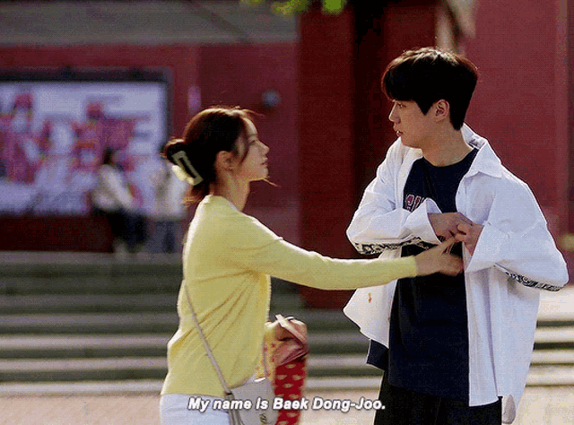 a man and a woman are standing next to each other and the woman says my name is beak dong joo