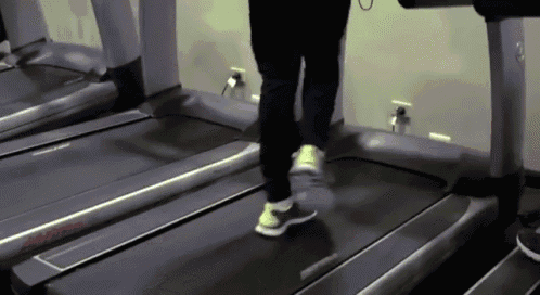 a person is walking on a treadmill that has the word reebok on it