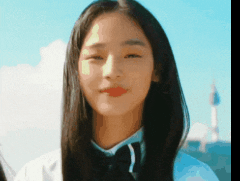 a close up of a woman 's face with long hair and a bow tie