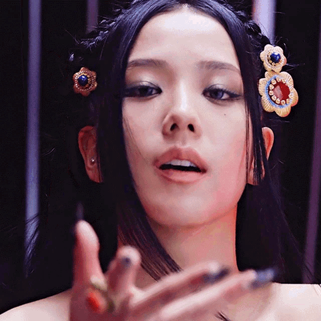a close up of a woman 's face with a hair clip in her hair