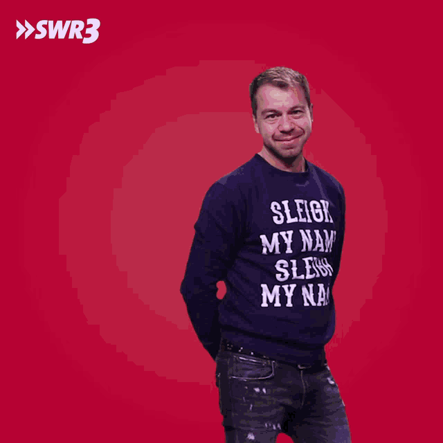 a man is wearing a sweater that says sleigh my name