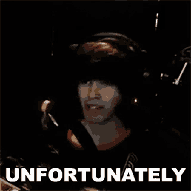 a man wearing headphones is smiling in front of a sign that says " unfortunately "