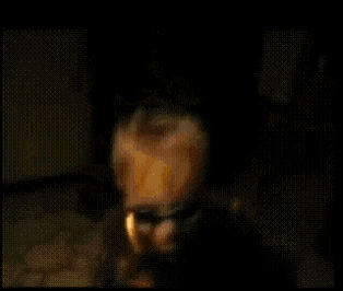 a blurry image of a person standing in front of a fireplace