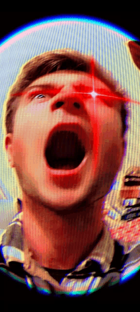 a close up of a man 's face with red eyes