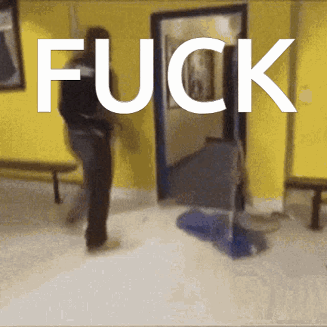 a person standing in front of a door with the word fuck on it