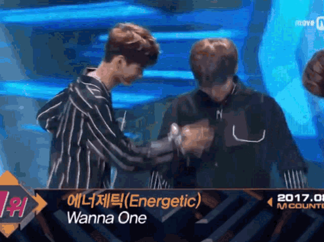 two men shaking hands in front of a sign that says energetic on it