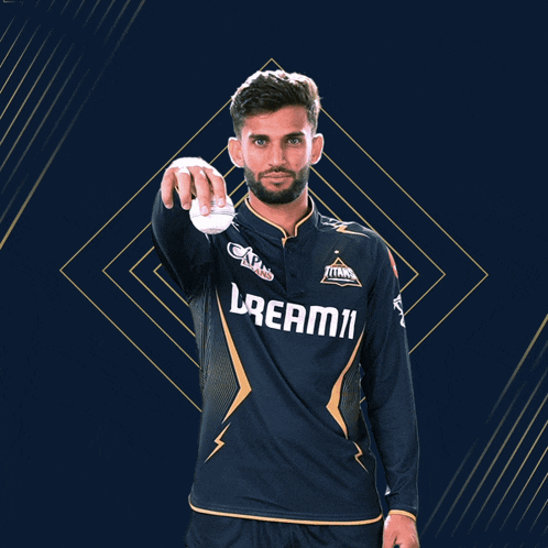 a man wearing a blue shirt that says dream11 on it
