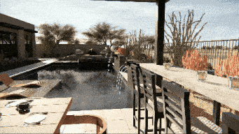 a computer generated image of a swimming pool with a table and chairs in the foreground