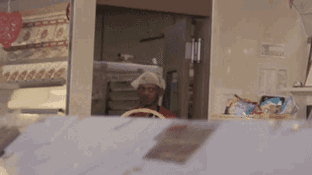 a man in a chef 's hat is behind a counter