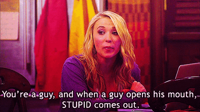 a woman in a purple shirt says " you 're a guy " when a guy opens his mouth
