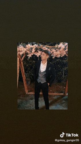 a man in a suit and tie is smoking a hookah with a tik tok watermark