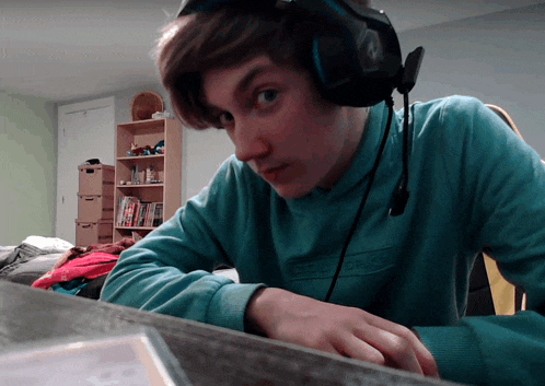 a young man wearing headphones and a blue sweater that says epdm on it