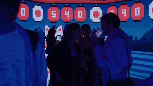 a group of people standing in front of a screen that says 400 540