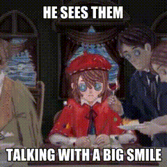 a girl in a red coat is sitting at a table talking with a big smile