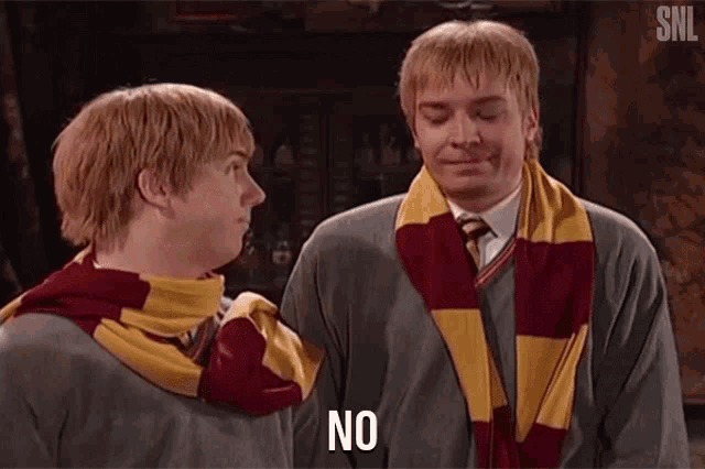 two men in harry potter costumes are standing next to each other and talking .