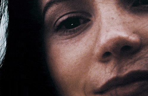 a close up of a woman 's face with a black eye