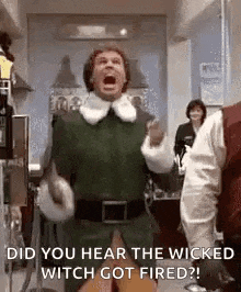 a man in a elf costume is screaming in a hallway .