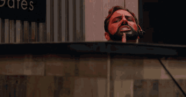 a man with a beard is wearing headphones and has his mouth open