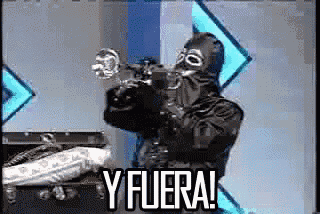 a man in a black mask is holding a gun and says y fuera !