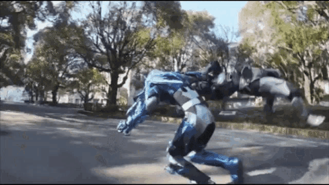a person in a robot suit is riding a skateboard down a street .