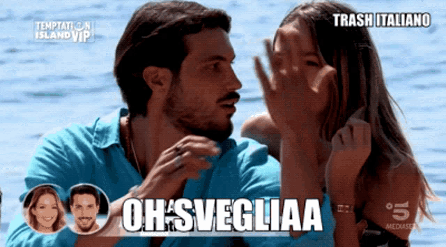 a man and a woman are looking at each other and the words oh svegliaa are on the screen