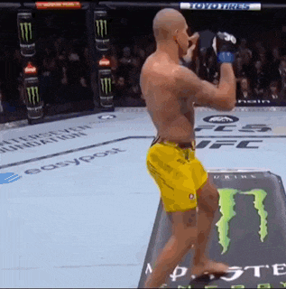 a man in yellow shorts is standing in front of a monster energy can