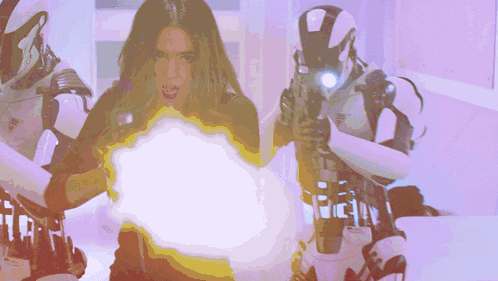 a woman is holding a gun in front of a robot with the letter t on it