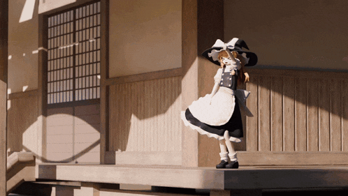 a doll wearing a black and white dress and hat is standing on a porch