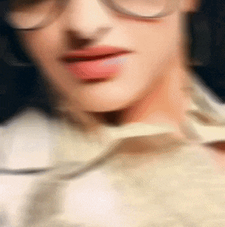 a blurry photo of a woman wearing glasses