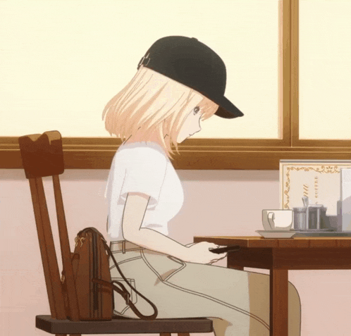 a girl in a baseball cap sits at a table with a menu behind her