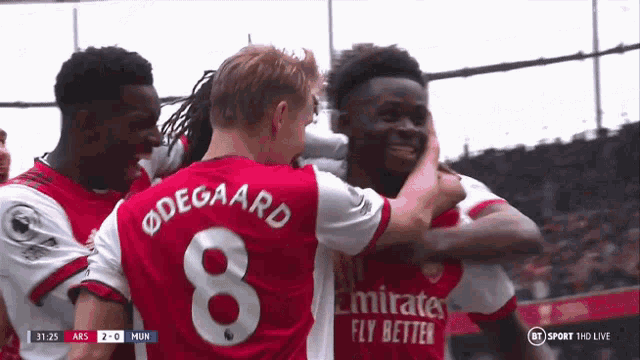 a soccer player with the number 8 on his jersey is hugging another player