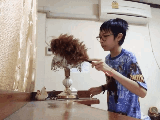a boy wearing a blue shirt that says kung fu on it