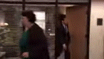 a blurry picture of a man and woman walking through a doorway .
