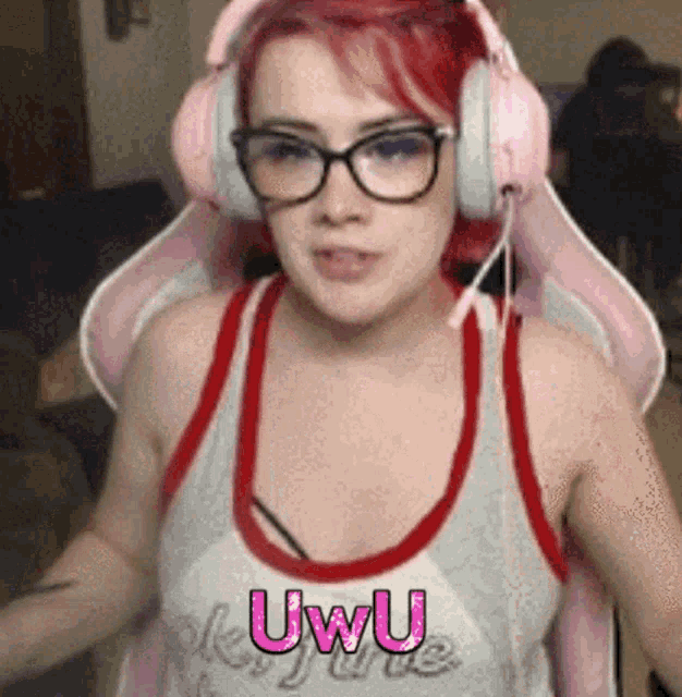 a woman wearing headphones and a tank top with the word uwu on it .