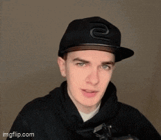 a young man wearing a black hat and a black hoodie
