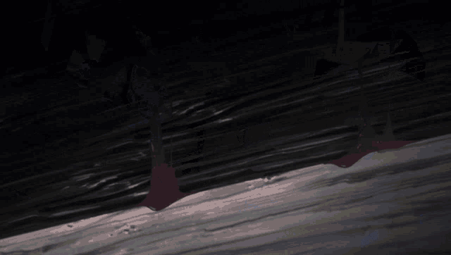 a red object is hanging from a rope in the dark